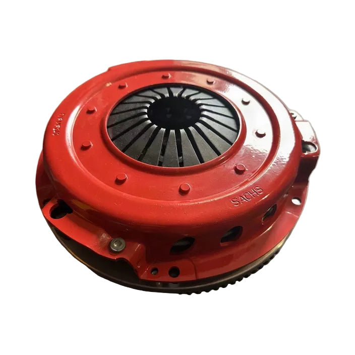 A red clutch pressure plate with a black flywheel visible in the center, photographed on a plain white background.