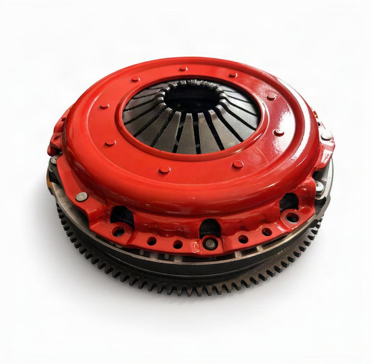 A red and black clutch assembly, likely a clutch pressure plate and flywheel, photographed on a clean white background.