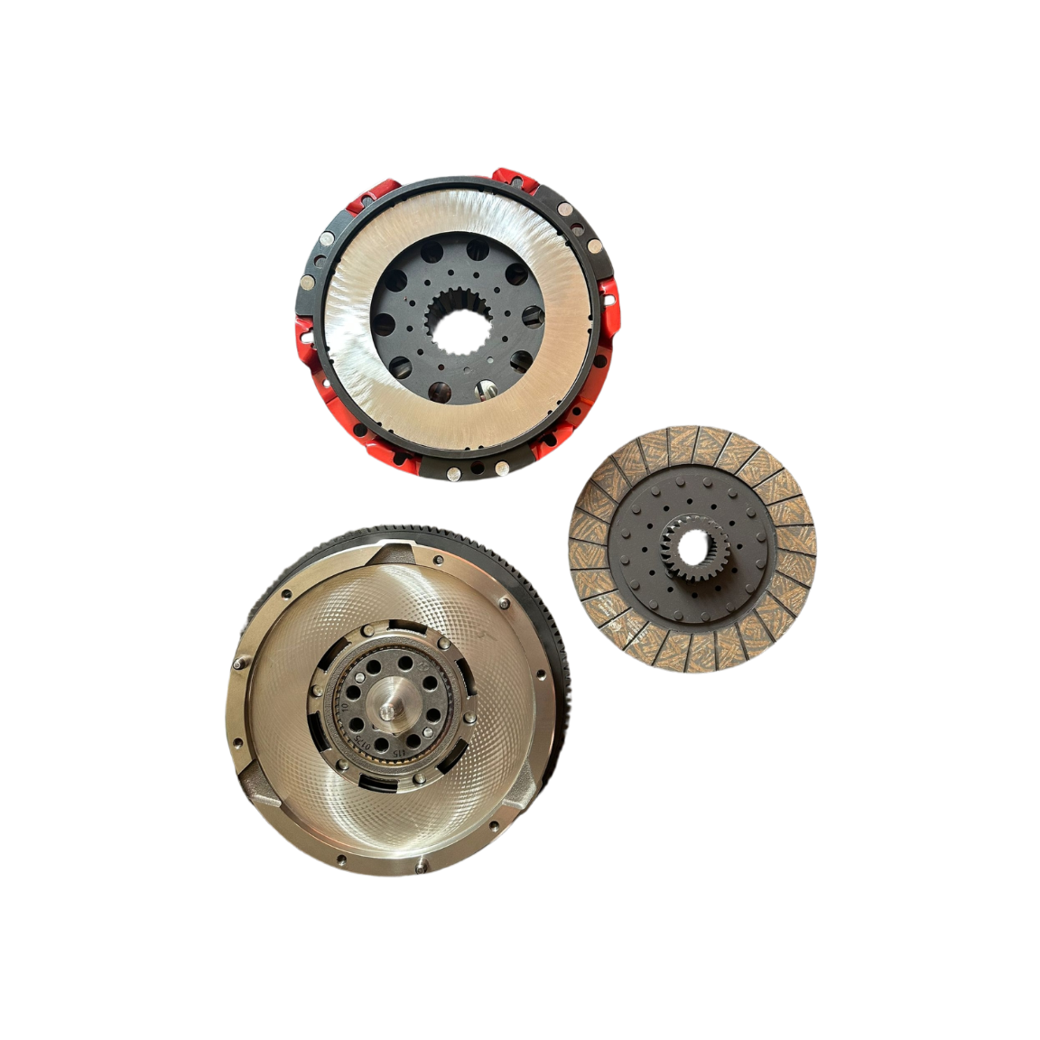 A set of three automotive clutch components, including a flywheel, a pressure plate, and a clutch disc, displayed on a solid white background.